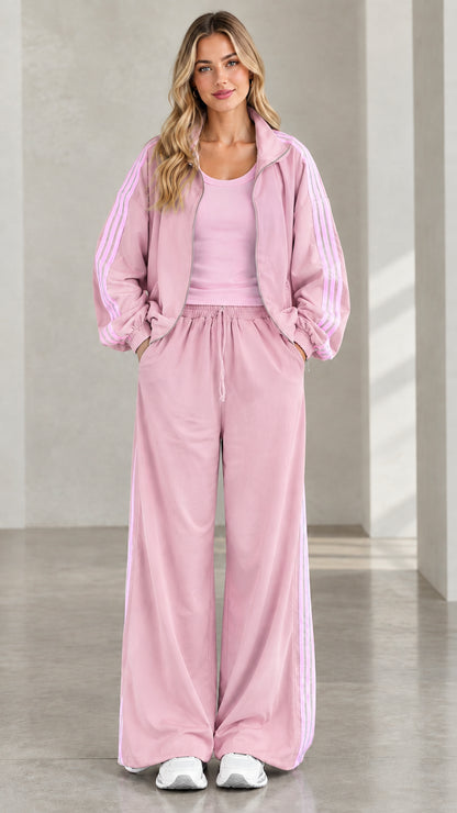 Front view of model wearing dusty pink tracksuit set with side stripes
