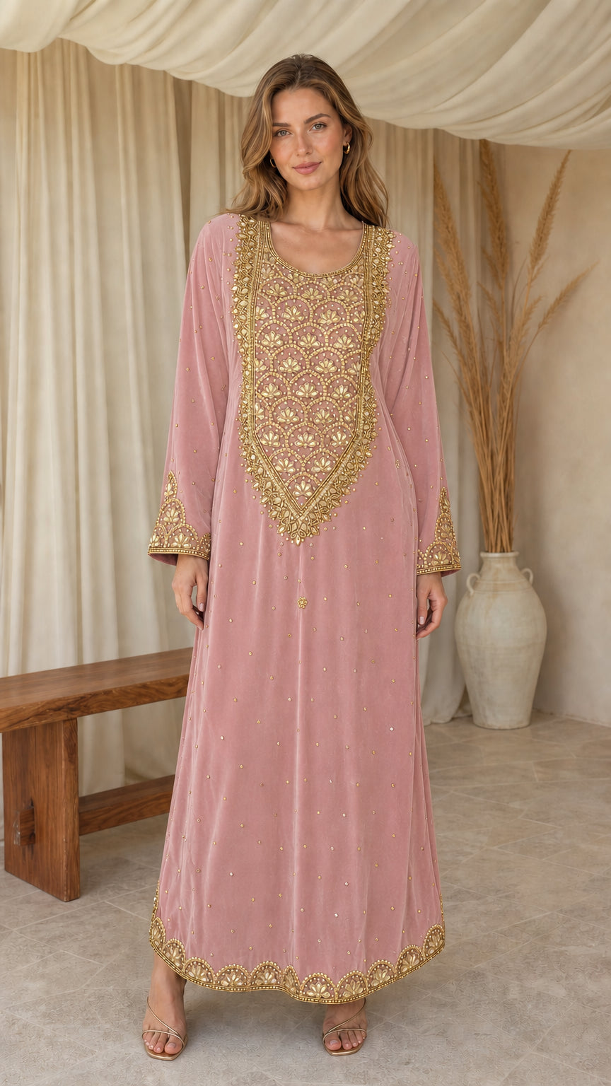 Model posing in dusty pink embroidered velvet maxi kaftan dress
