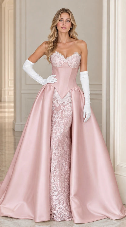 Model wearing dusty pink strapless formal gown with lace column skirt and satin overskirt
