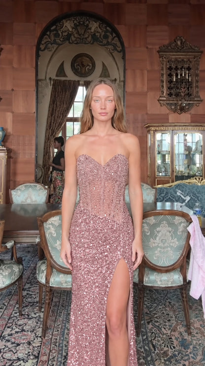 Front view of model wearing rose pink strapless sequin corset maxi gown