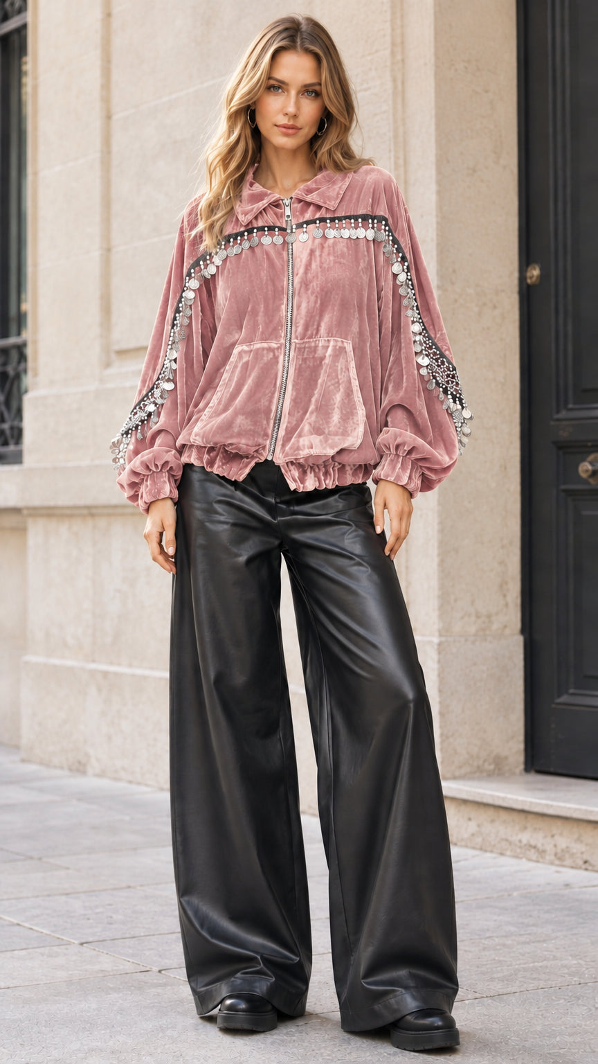 Model wearing dusty pink velvet zip-up jacket with coin fringe trims