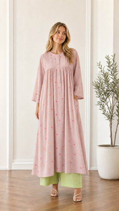 Front view of woman wearing dusty pink floral pleated maxi dress