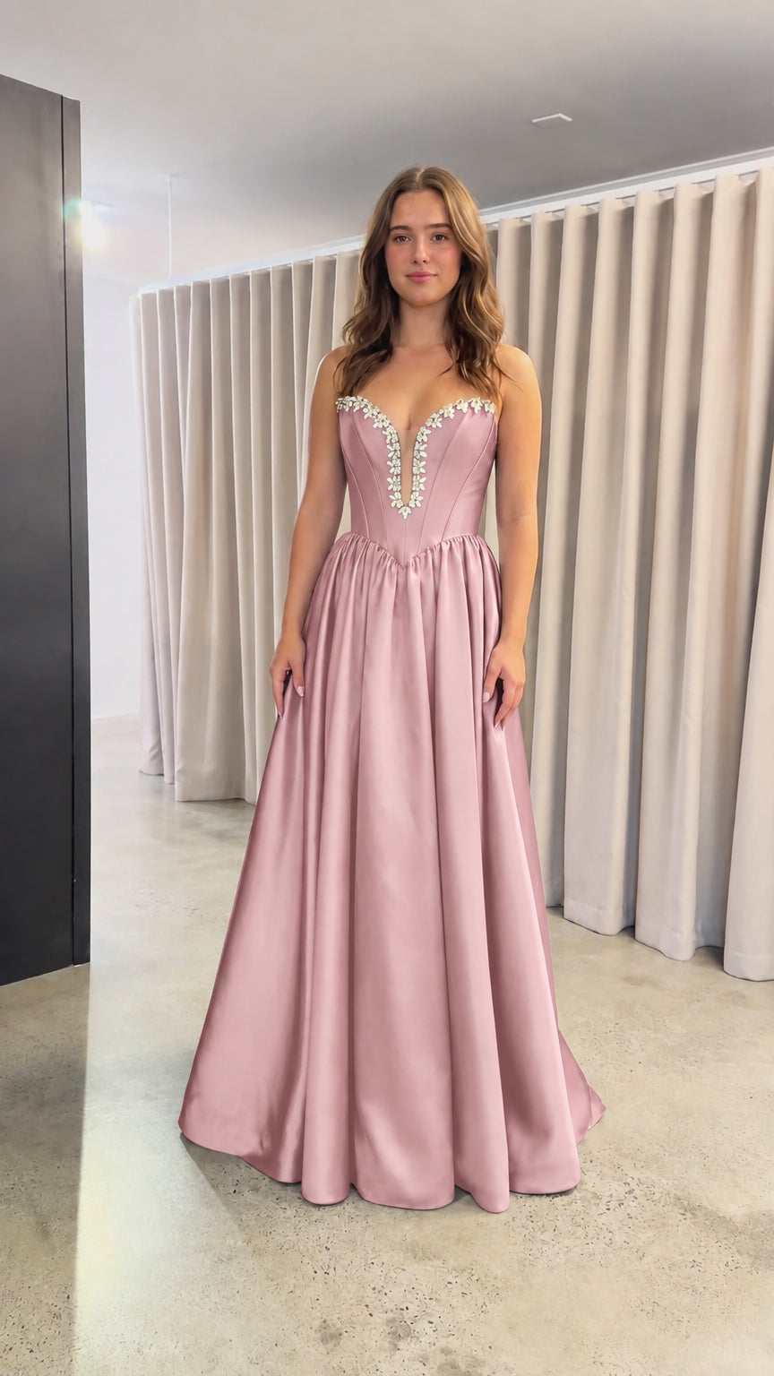 Front view of blush pink strapless satin evening dress with crystal trim