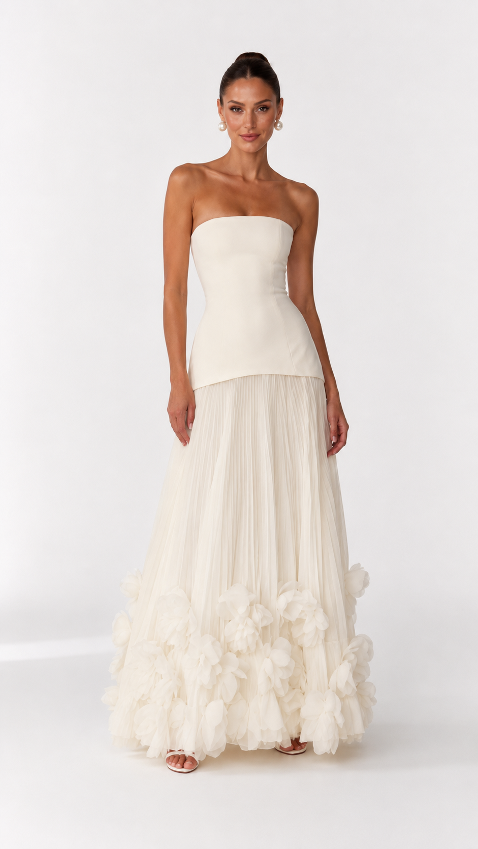 Front view of ivory strapless gown with sculpted bodice and soft pleated skirt