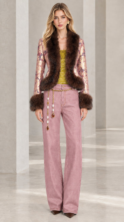 Model wearing rose pink floral jacquard jacket with faux fur trim and matching trousers
