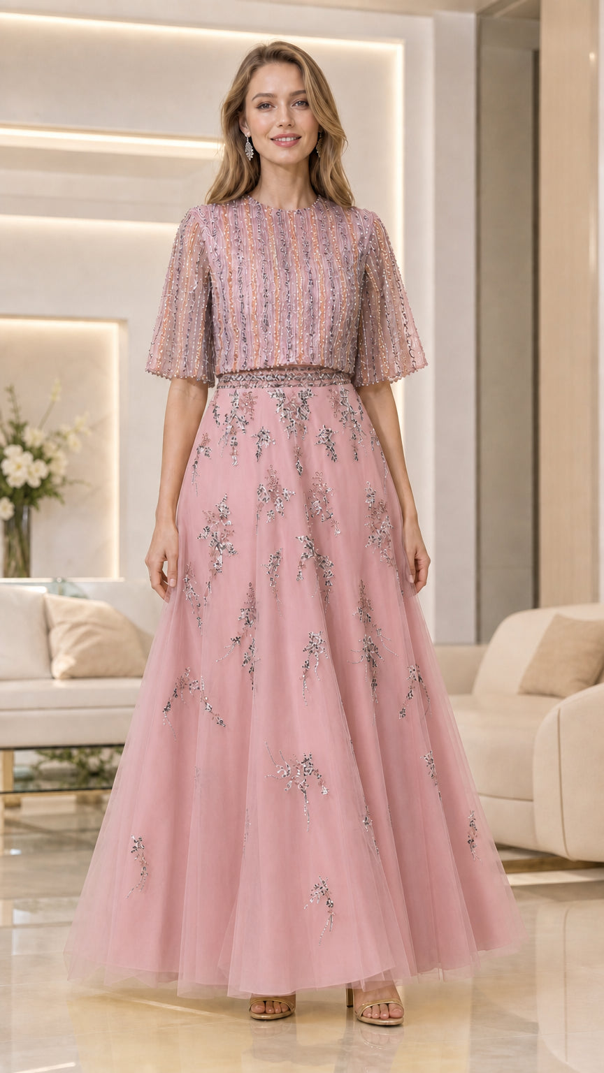 Model wearing dusty pink beaded flutter-sleeve tulle evening gown