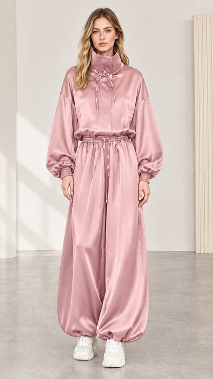 Full front view of model wearing blush pink satin high neck balloon jumpsuit