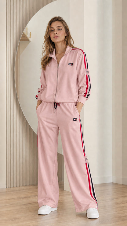 Model wearing dusty pink 2-piece track jacket and wide-leg pant set
