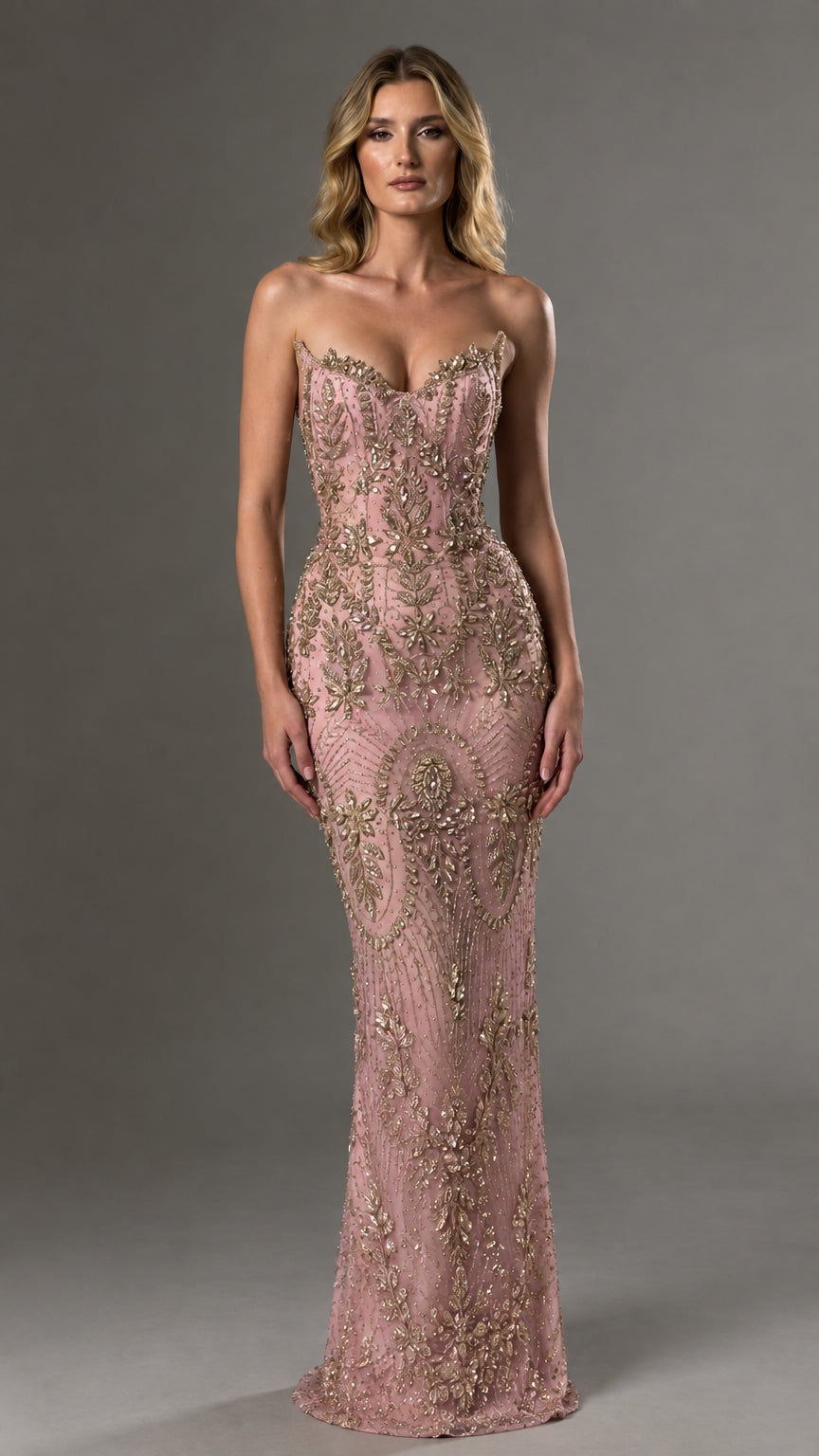 Front view of model wearing blush pink and gold strapless beaded evening dress