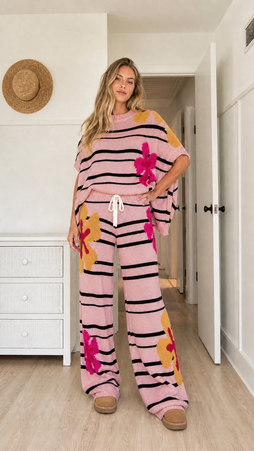Model wearing light pink floral striped knit short sleeve top and pants set