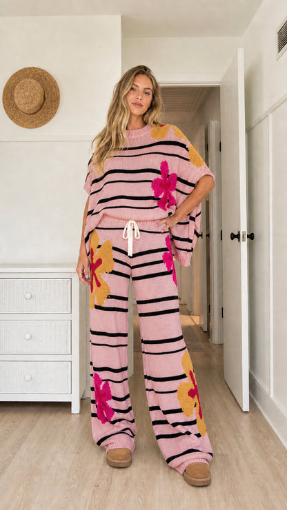 Model wearing light pink floral striped knit short sleeve top and pants set