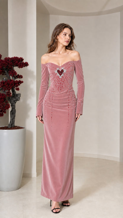 Front view of model wearing dusty rose velvet off-the-shoulder maxi dress