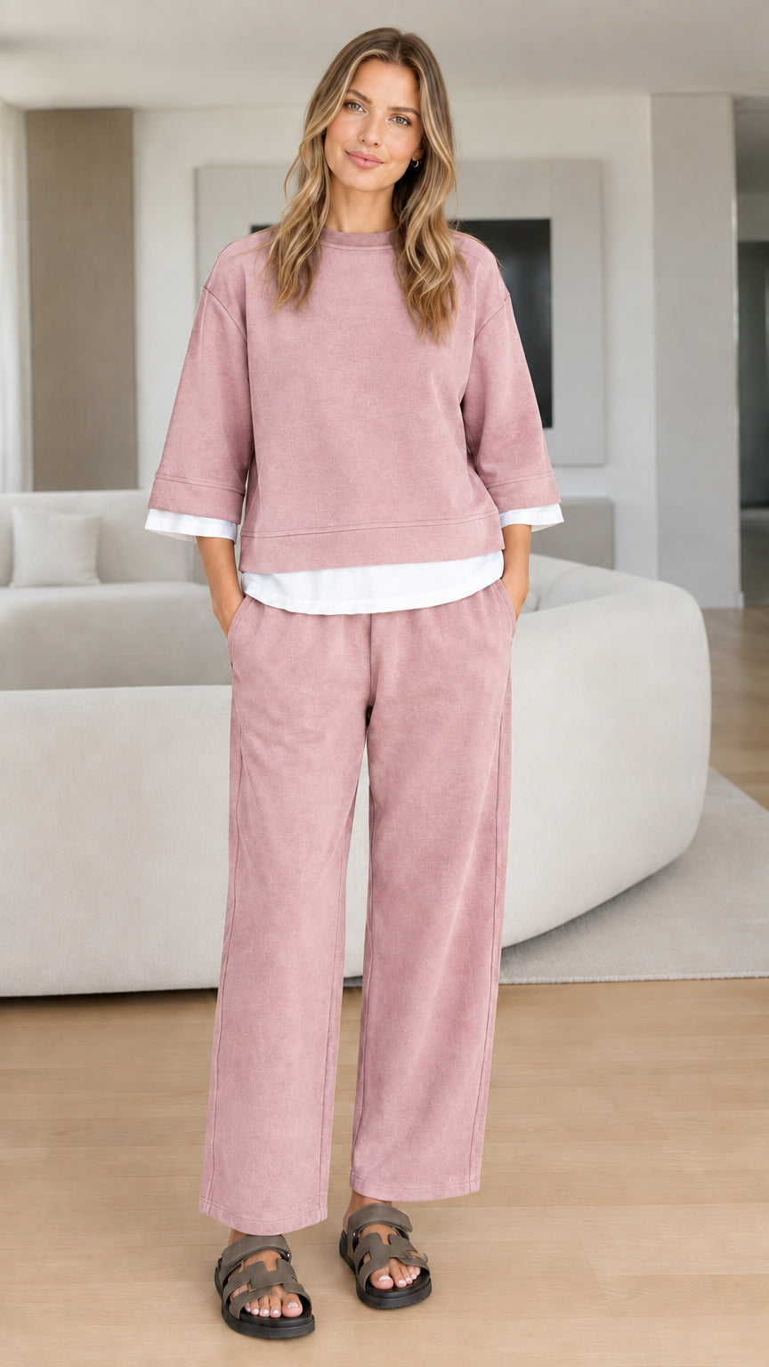 Full-body studio view of woman in dusty rose pink two-piece sweatshirt lounge set