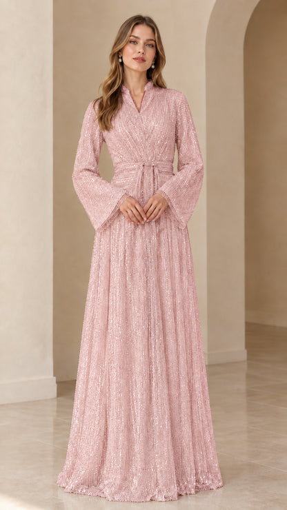 Front view of model wearing blush pink sequined long sleeve maxi dress