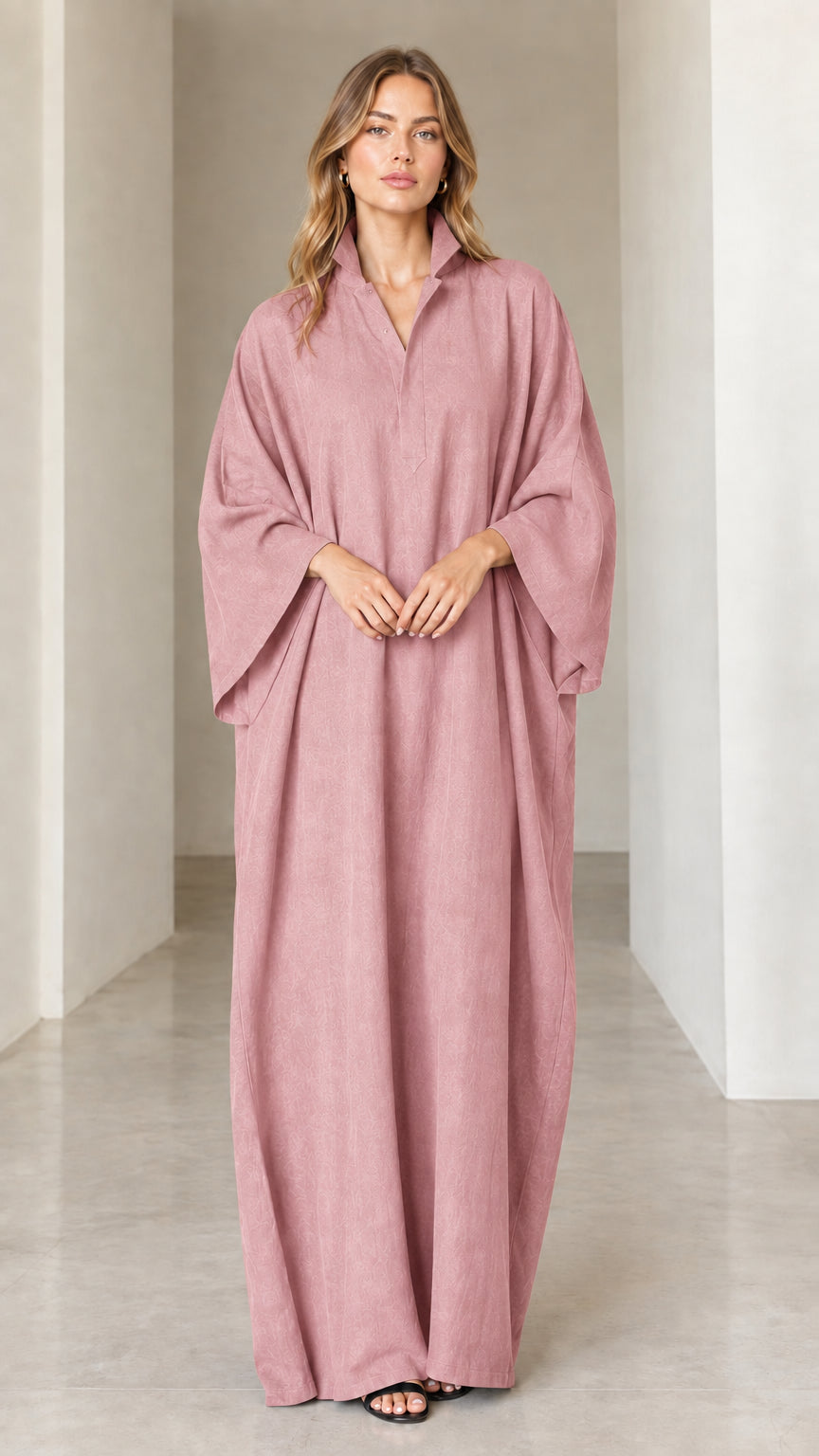 Model wearing dusty rose pink oversized collared maxi kaftan dress