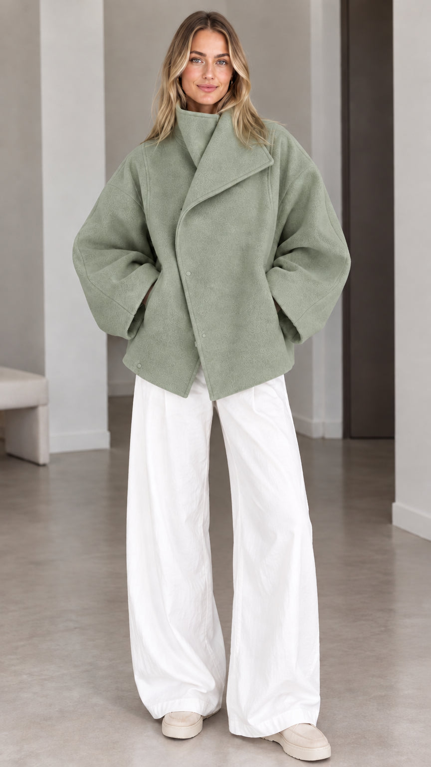 Model wearing sage green oversized high collar short outerwear jacket