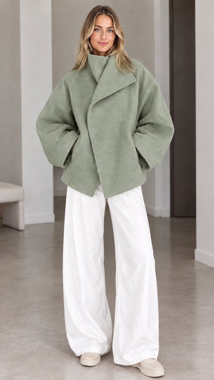 Model wearing sage green oversized high collar short outerwear jacket