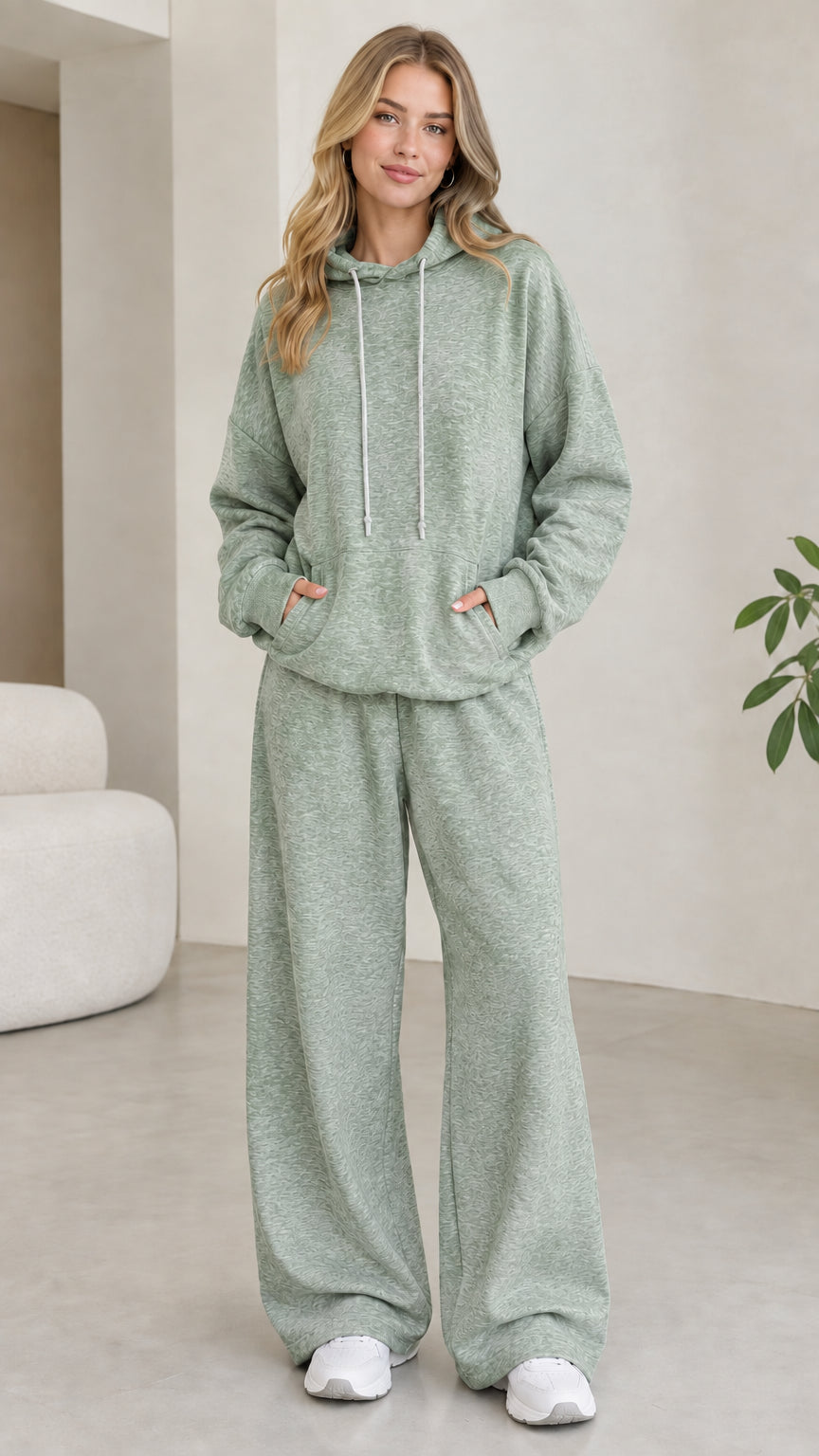 Model wearing sage green 2-piece drawstring hoodie and wide leg sweatpants set