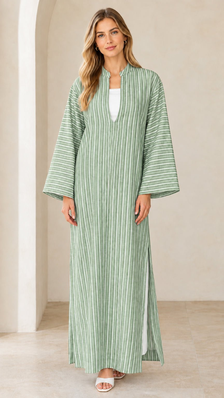Woman wearing sage green vertical striped maxi kaftan dress