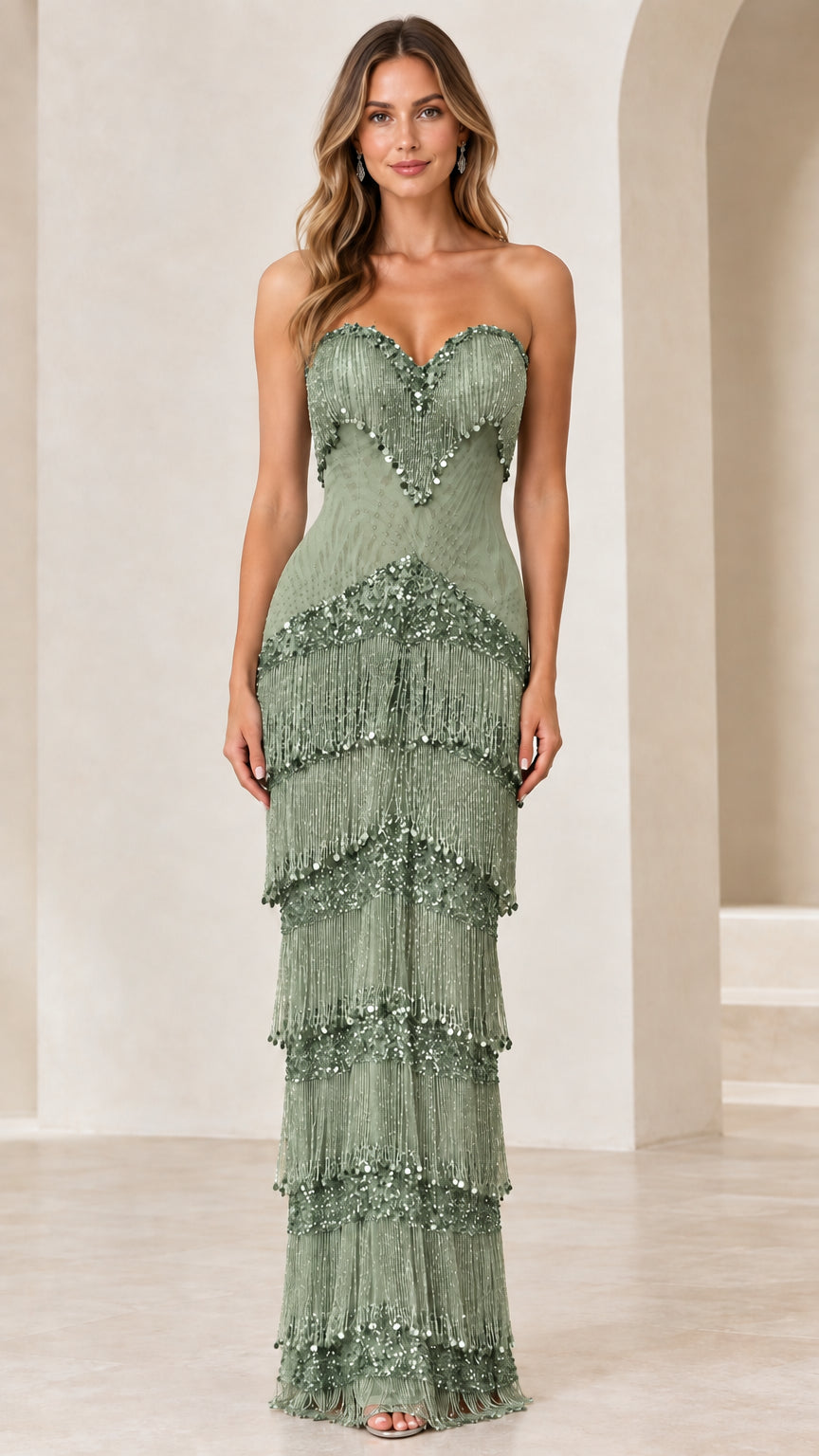 Front view of woman wearing sage green strapless tiered fringe evening gown