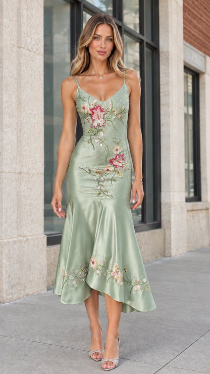 Model wearing sage green floral embroidered satin evening dress