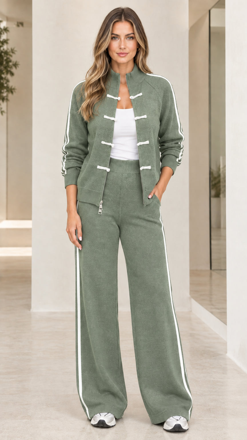 Woman wearing sage green two-piece knit tracksuit set with white side stripes