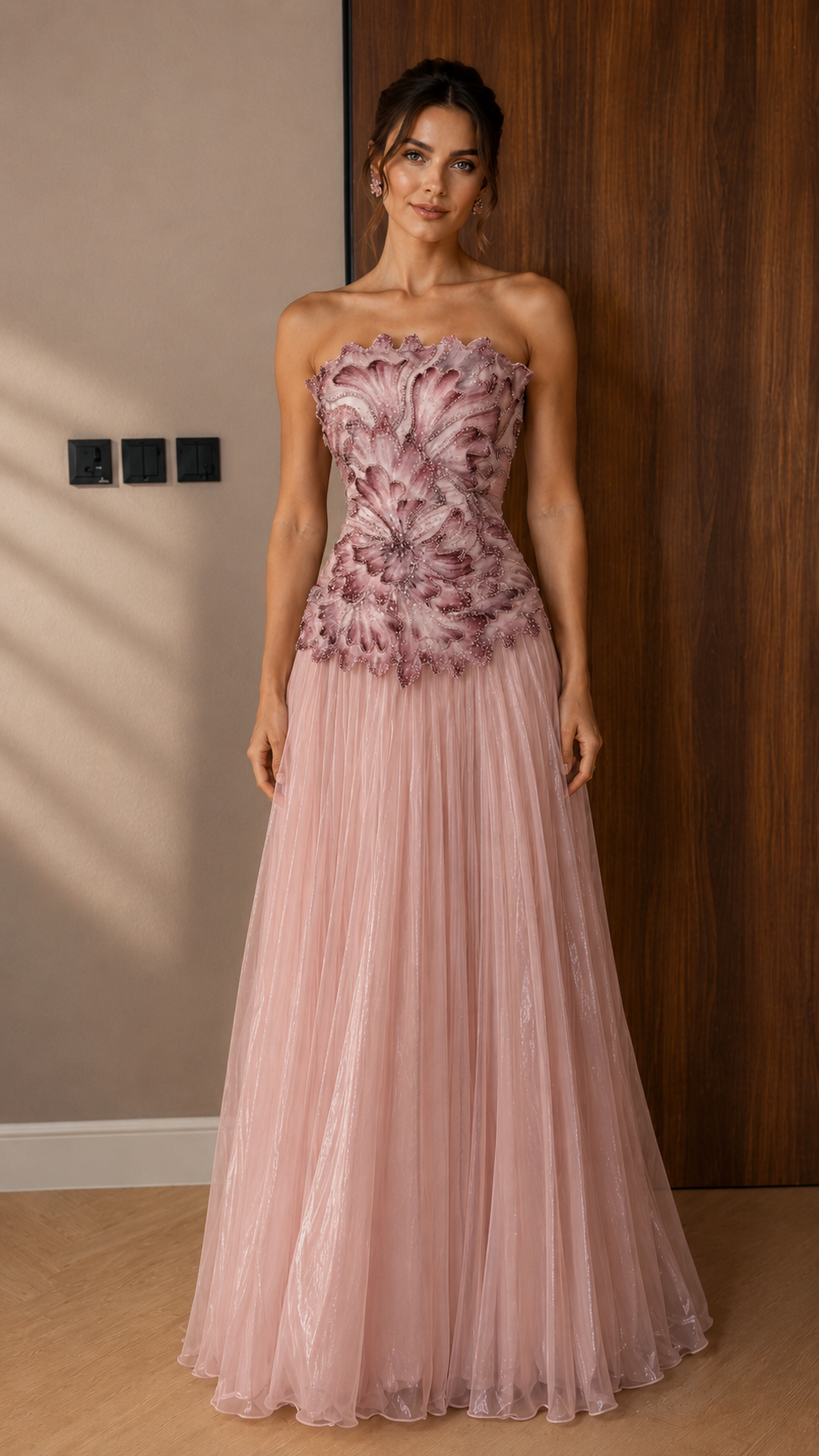 Front view of blush pink strapless embroidered evening dress with flowing pleated skirt