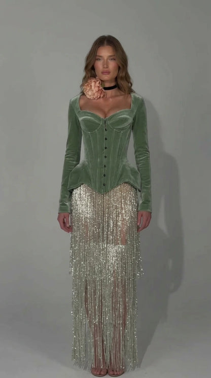 Front view of sage green velvet corset dress with shimmering fringe overlay