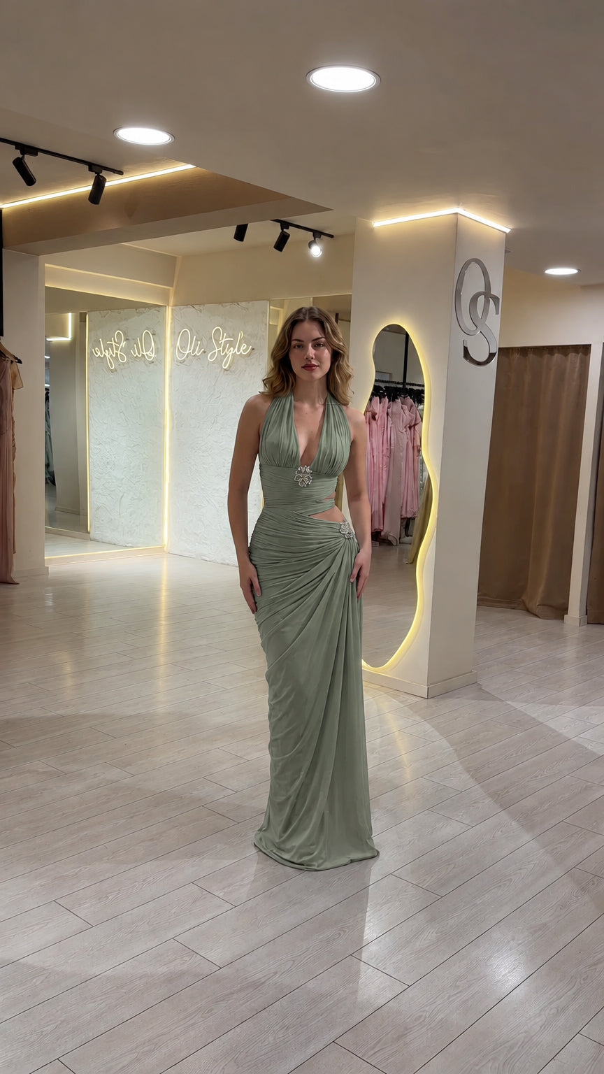 Front view of model wearing Sage Green halter cutout evening maxi dress