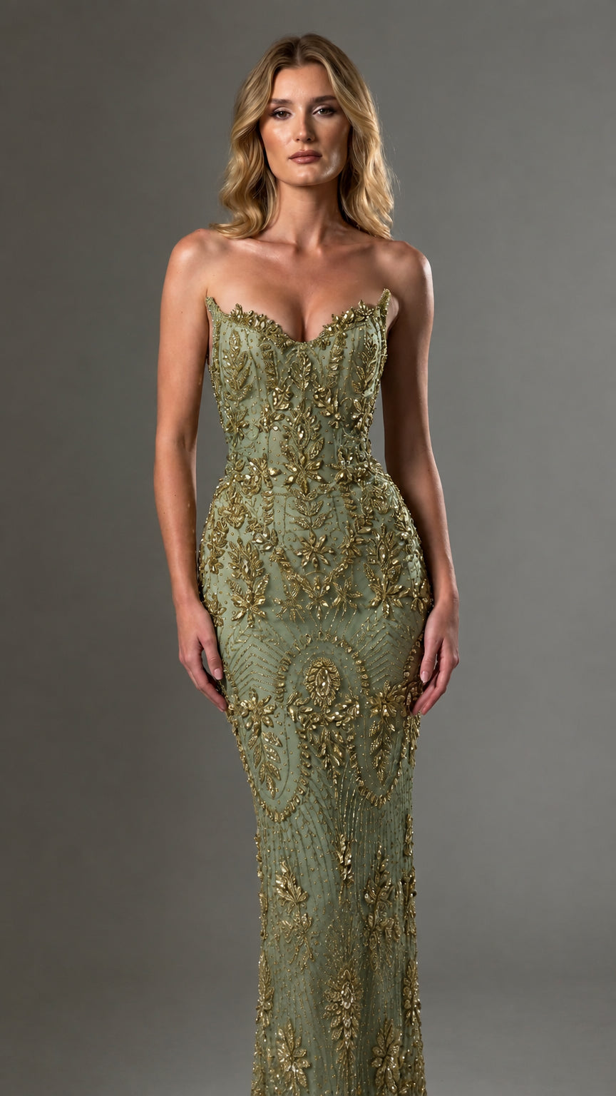 Front view of model wearing sage green and gold strapless embellished maxi gown