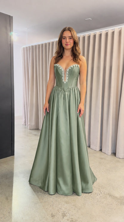 Front view of sage green strapless satin evening dress with crystal trim