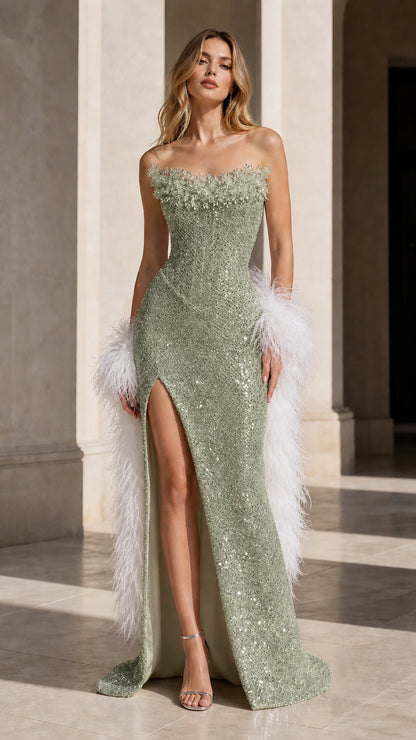 Model wearing sage green strapless sequin evening dress with high slit