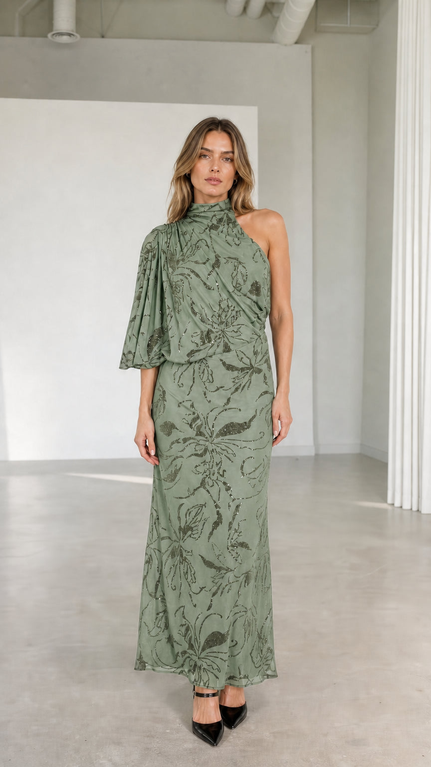 Model wearing sage green one-shoulder high neck embellished maxi dress