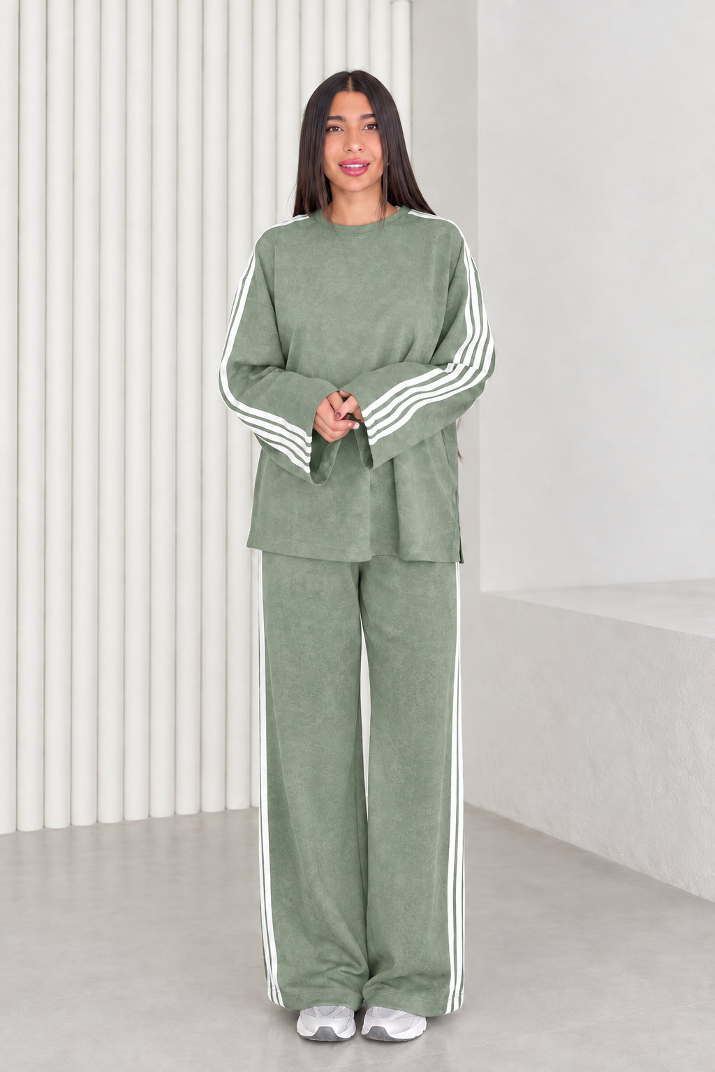 Full length view of model wearing sage green two-piece striped lounge set