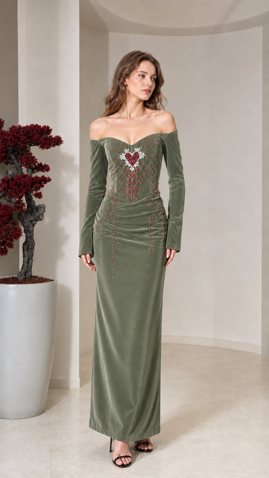 Front view of model wearing sage green velvet off-the-shoulder maxi dress