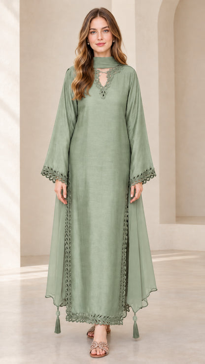 Front view of model wearing sage green embroidered maxi kaftan dress with scarf neckline
