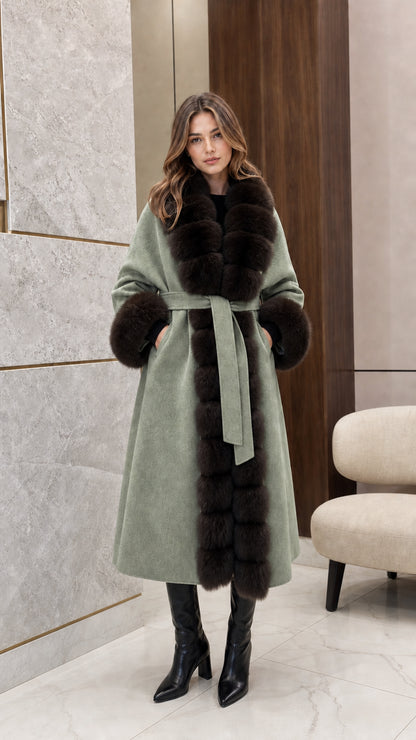Front view of woman wearing the sage green belted longline coat with dark fur trim