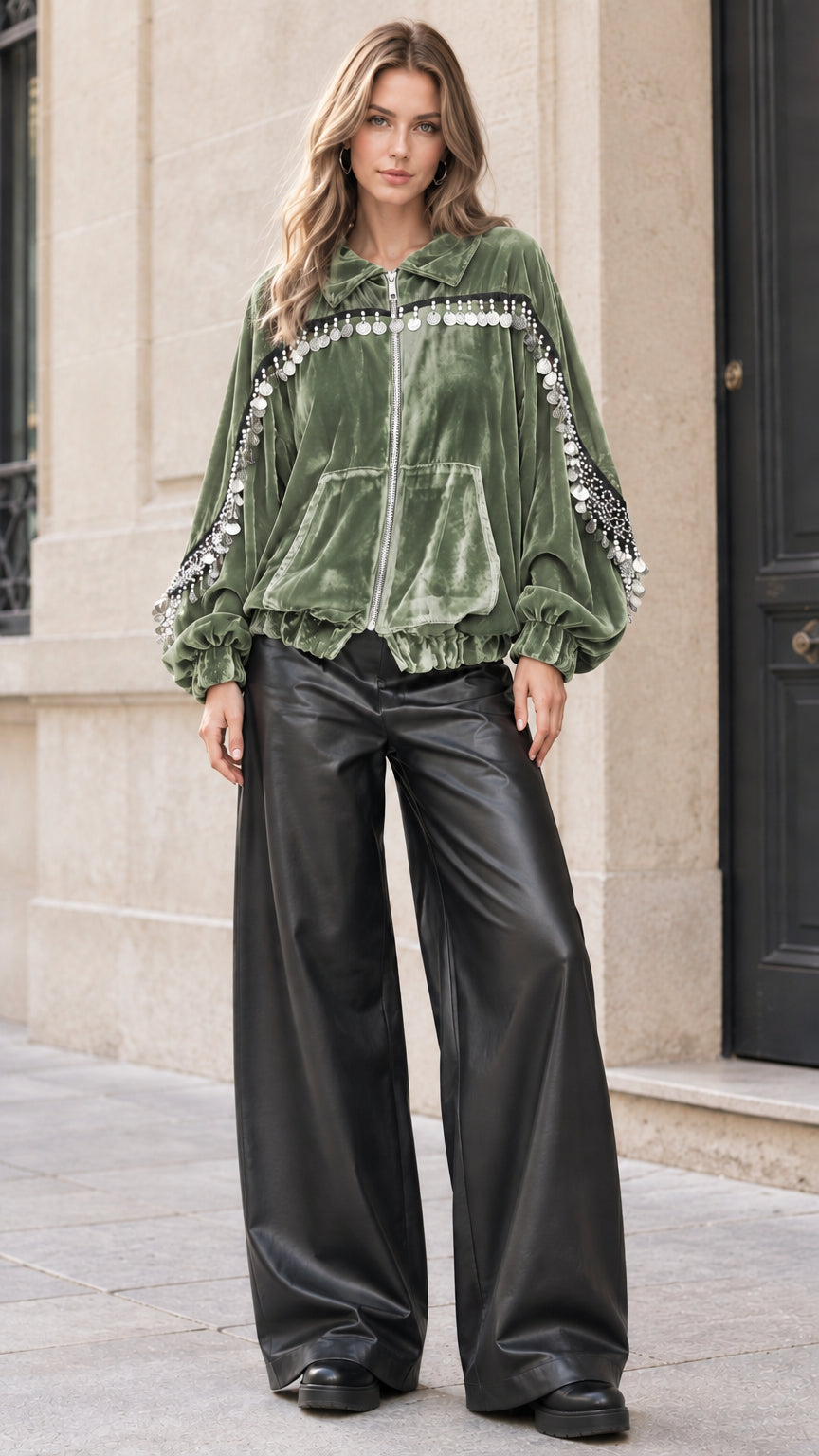 Model wearing sage green velvet bomber jacket with metallic fringe