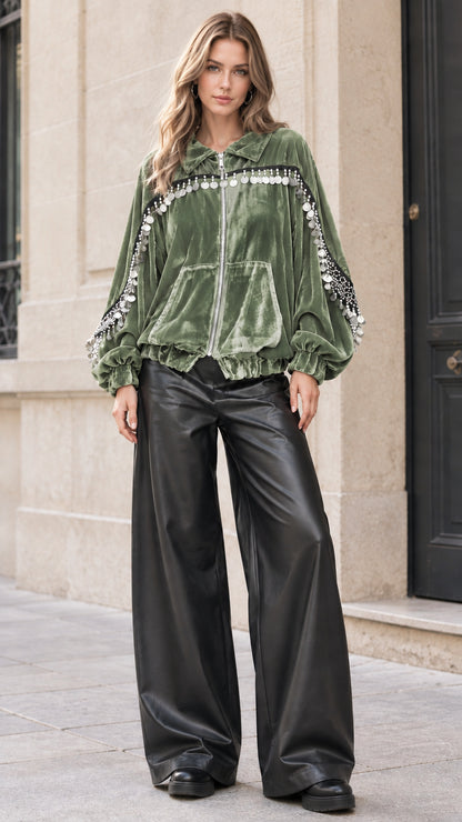 Model wearing sage green velvet bomber jacket with metallic fringe