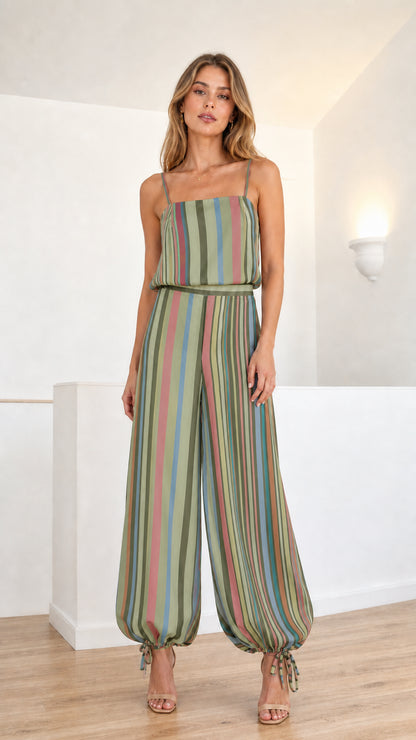 Model wearing sage green multi-colored striped cami jumpsuit