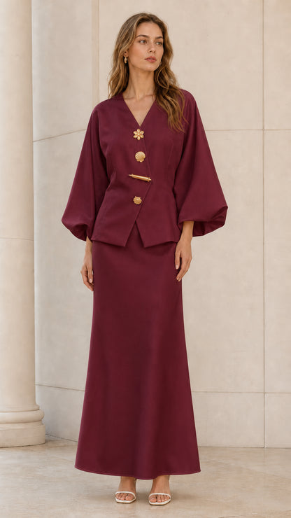 Front view of model wearing burgundy wine lantern sleeve top and maxi skirt set with gold buttons