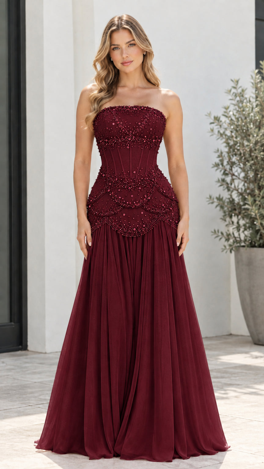 Model wearing Burgundy red strapless beaded corset formal maxi gown