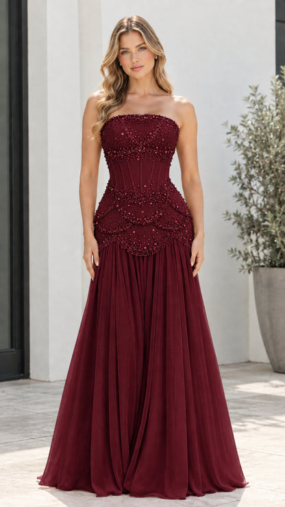 Model wearing Burgundy red strapless beaded corset formal maxi gown