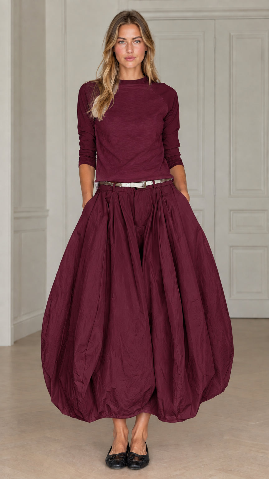 Full front view of women's monochrome two-piece bubble skirt outfit in rich burgundy