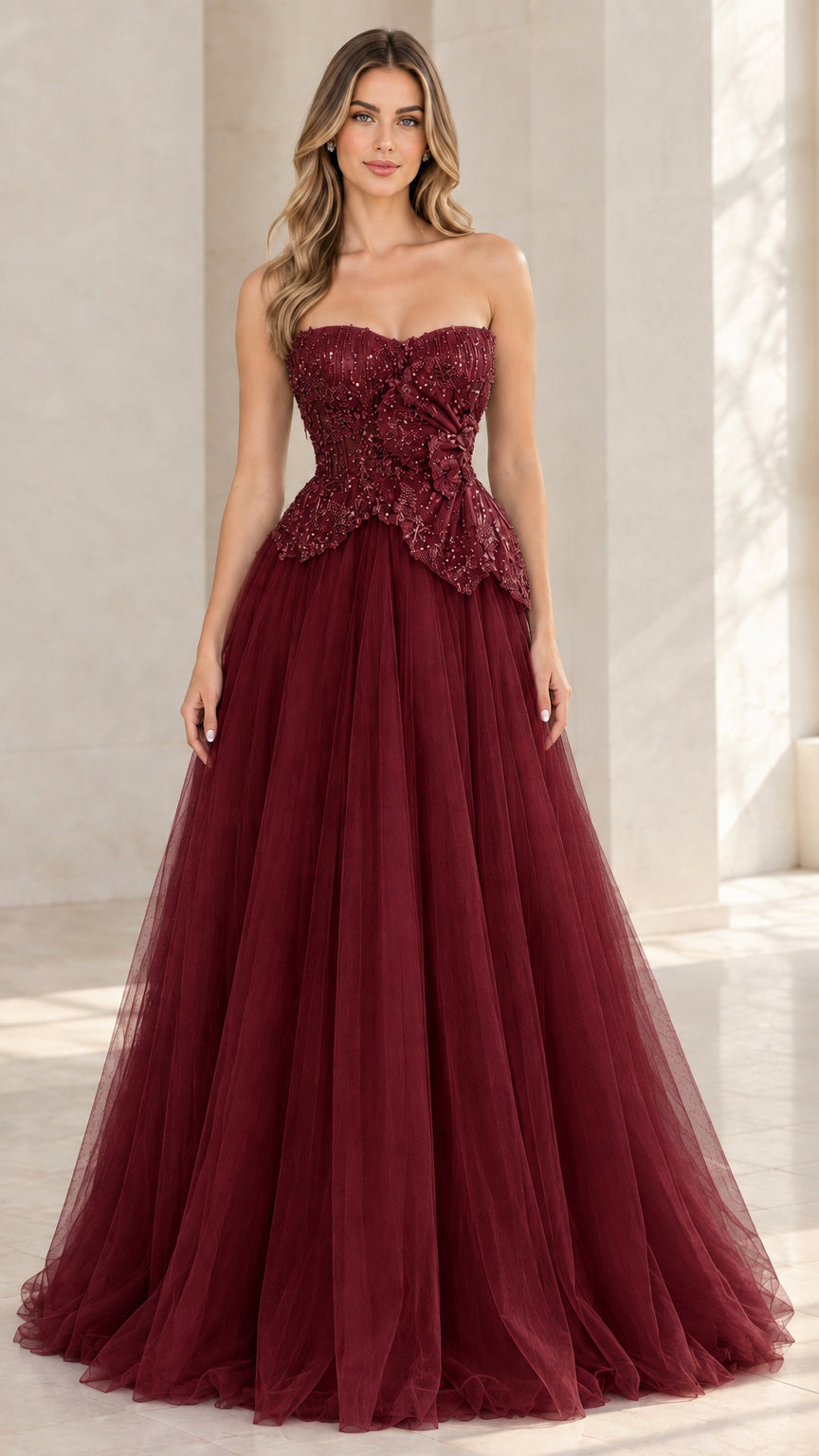 Model wearing burgundy red strapless beaded tulle evening dress