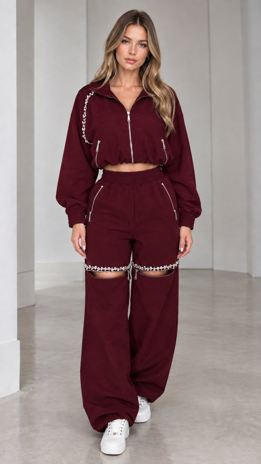 Model wearing burgundy wine cropped zip jacket and rhinestone cut-out wide leg pants set