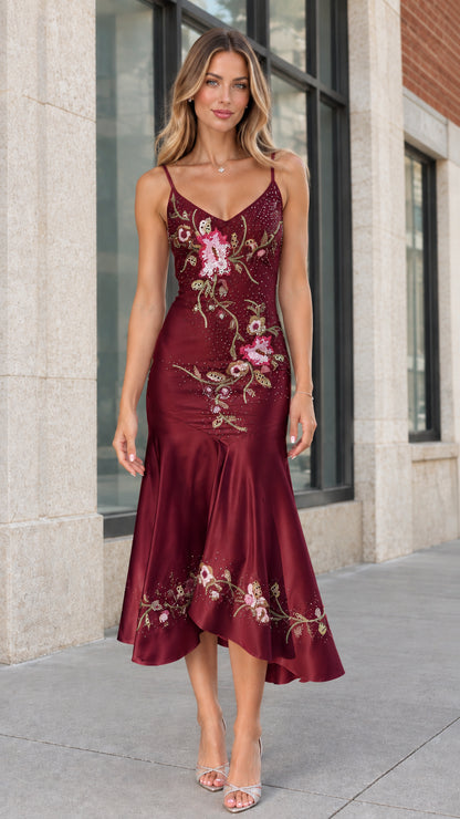 Model wearing burgundy red beaded satin cocktail midi dress
