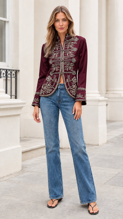 Model wearing rich burgundy embroidered stand collar jacket with denim jeans