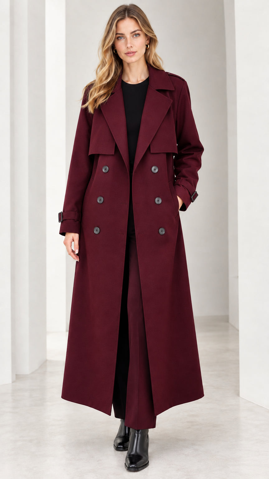 Front view of woman wearing burgundy wine red maxi double-breasted trench coat