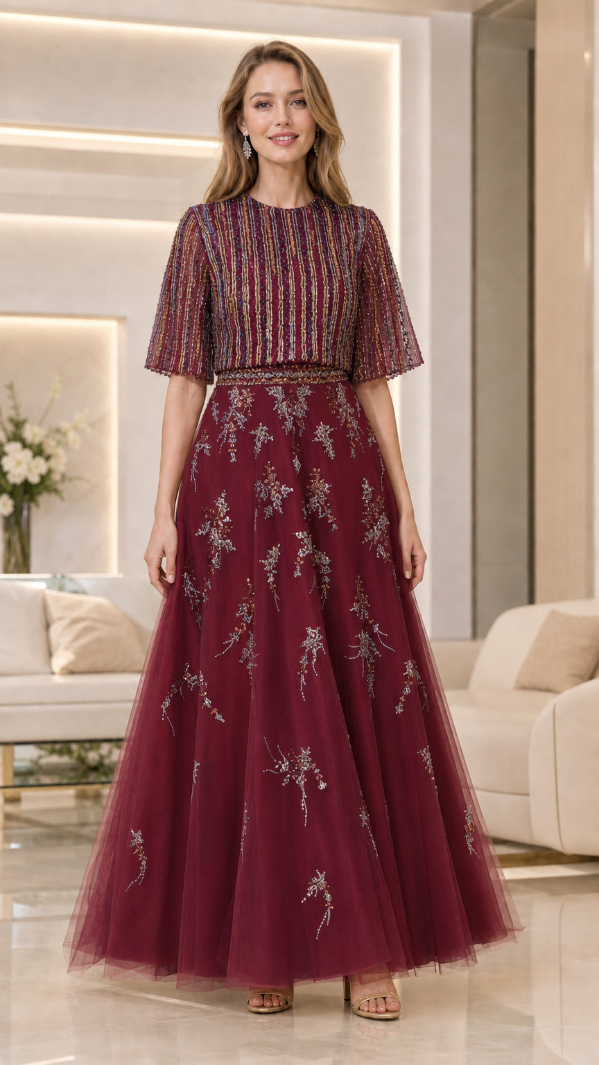 Model wearing burgundy beaded flutter-sleeve tulle evening gown